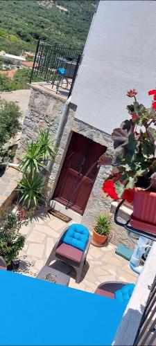 a patio with two chairs and a door with plants at Villa Sarichel in Nikithianós