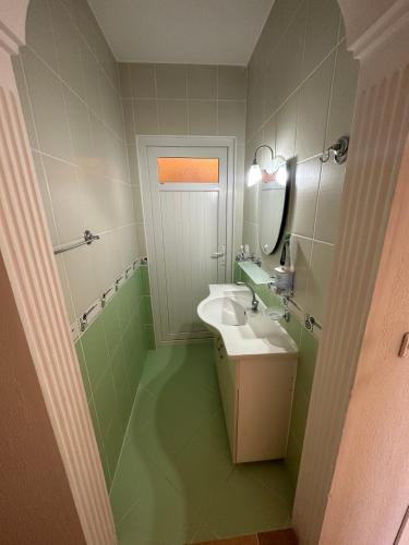 a bathroom with a sink and a mirror at Aysel Villa in Ortaca