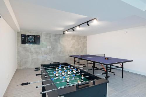 two ping pong tables in a room with two tables at Seaside Escape Pet Friendly Apartments Mielenko by Renters in Mielenko