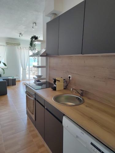 a kitchen with a sink and a counter top at Apartment Čiovo Radić in Trogir