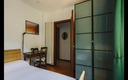 a bedroom with a bed and a table and a desk at Harry's Villa Lenno - Lake Como in Lenno