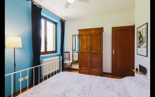 a bedroom with a large bed and a window at Harry's Villa Lenno - Lake Como in Lenno
