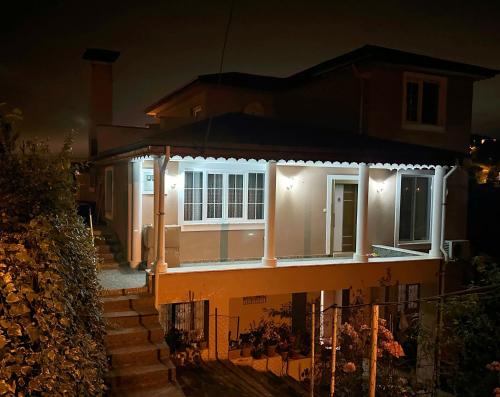 a house with lights on the front of it at night at COUNTRY HOME in Trabzon