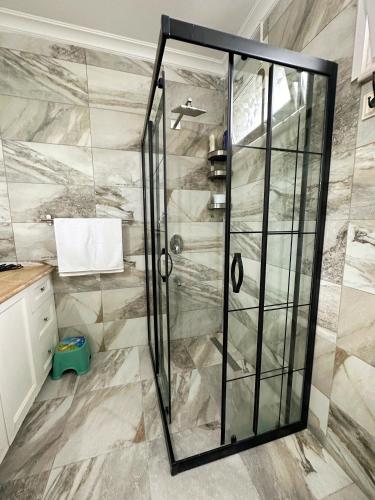 a shower with a glass door in a bathroom at Country Home in Trabzon