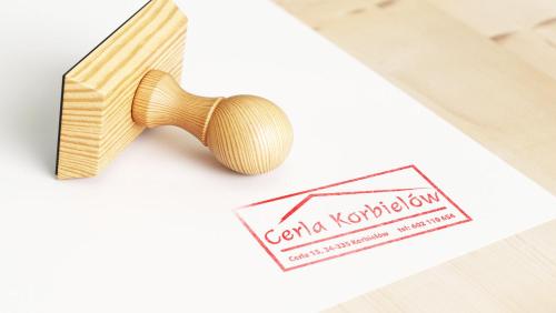 um martelo de madeira ao lado de um cartão de visita e um papel em Cerla Korbielów - Domek dla Dwojga em Korbielów