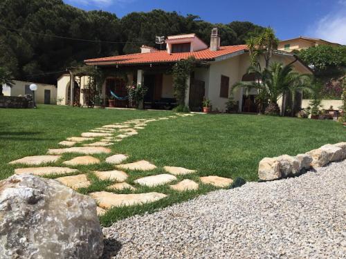a garden with a stone pathway in front of a house at Aethalia Bed and Breakfast in Portoferraio