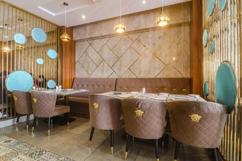 a dining room with tables and chairs and a wall at FabHotel Double Tree in Hyderabad