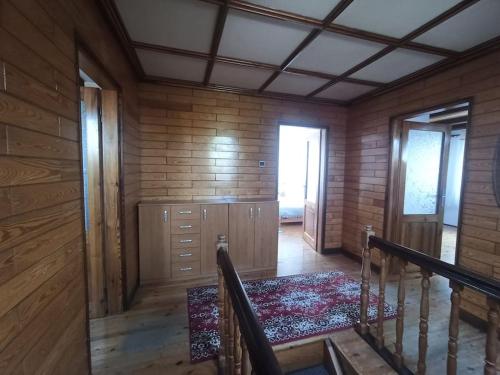 an empty room with a staircase in a wooden house at Apartament Pod Orzechem in Augustów