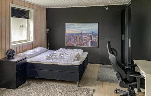 a bedroom with a bed and a desk and a chair at Awesome Home In Vgstranda With Wifi in Hjelvik