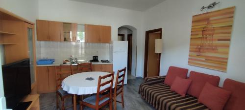 a kitchen with a table and a couch in a room at Apartment Štrbić in Ploče