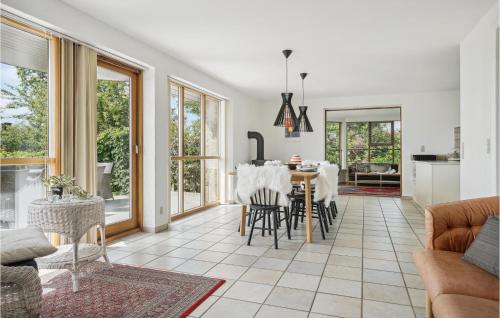 a kitchen and living room with a table and chairs at Gorgeous Home In Øster Assels in Øster Assels