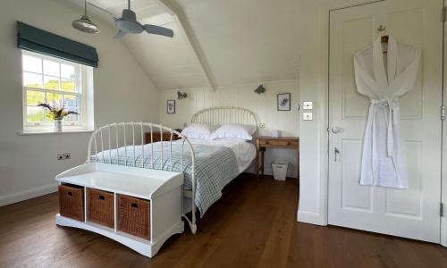 a bedroom with a white bed and a window at Dyffryn in Newport Pembrokeshire