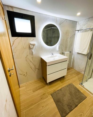a bathroom with a sink and a mirror at House 9 Guimarães in Guimarães
