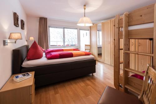 a small room with a bed and a bunk bed at Spacious Corner apartment in Aparthotel Kleinwalsertal in Mittelberg