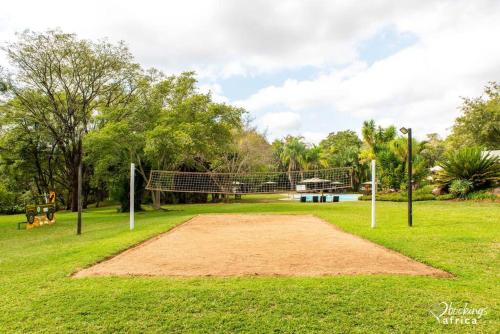a field with a volleyball net in a park at Kruger Park Lodge Unit No. 254 in Hazyview