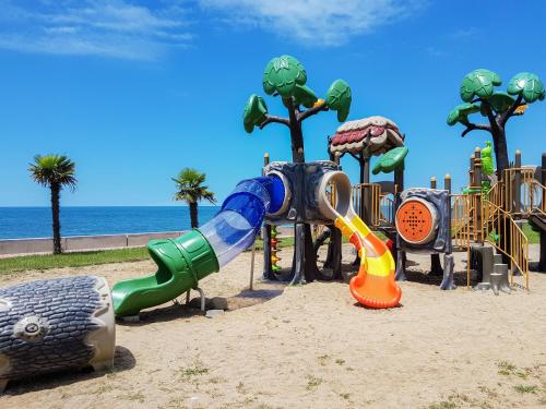 a playground on the beach with a slide and slidesktop at Luxury Dreamland Oasis Apartments in Chakvi