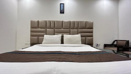 a bedroom with a large bed with a large headboard at Park Studio DLF Phase 2, Cyber City, Gurgaon in Gurgaon