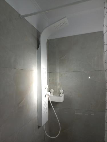 a bathroom with a shower with a light on the wall at Sandra's luxury stay in Akti Salonikiou