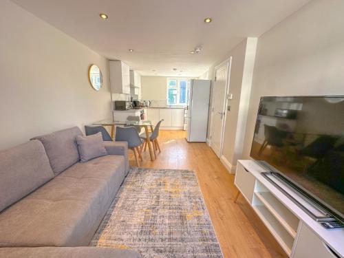 a living room with a couch and a flat screen tv at Parkway residences in London