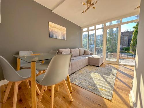 a living room with a table and a couch at Parkway residences in London
