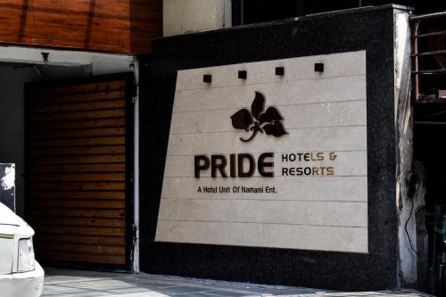 a garage door with a sign that reads pride and records at Pride Hotel And Resort Rishikesh in Rishīkesh