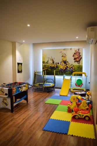 a childrens room with two beds and a play area at Pride Hotel And Resort Rishikesh in Rishīkesh