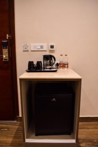 a kitchen counter with a sink and a stove at Pride Hotel And Resort Rishikesh in Rishīkesh