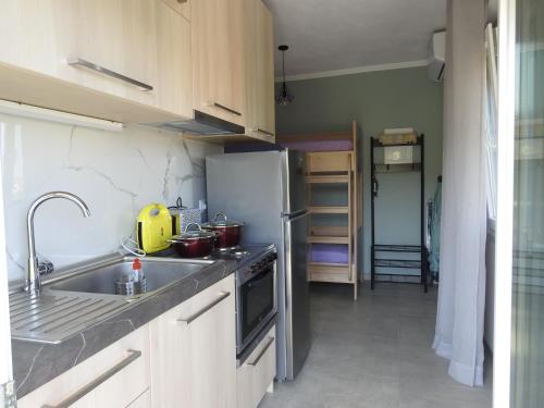 a kitchen with a stainless steel refrigerator and a sink at Sandra's luxury stay in Akti Salonikiou