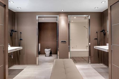 a bathroom with a toilet and a shower at AC Hotel Iberia Las Palmas by Marriott in Las Palmas de Gran Canaria