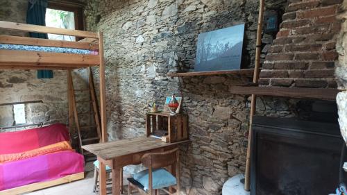 a room with a bed and a table and a fireplace at Chambre insolite in Saint-Mathieu