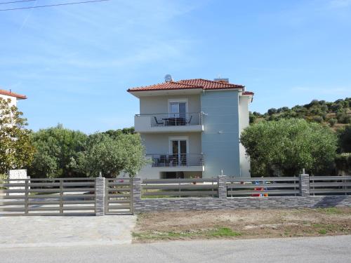 a white house with a fence in front of it at Sandra's luxury stay in Akti Salonikiou