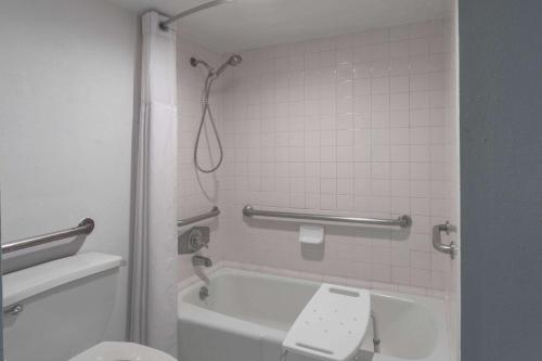 a bathroom with a tub and a toilet and a shower at Super 8 by Wyndham Ocala I-75 in Ocala
