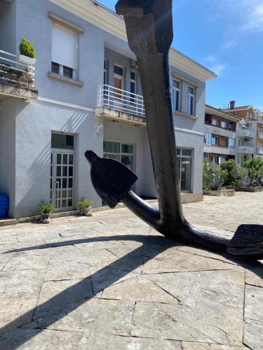a statue of a tree in front of a building at Apartment SIDRO Tivat in Tivat