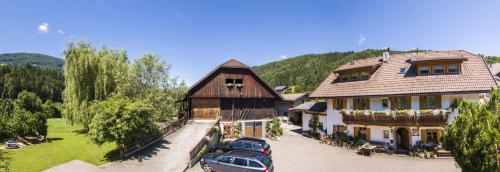 a large building with cars parked in front of it at Haus Ploner - Pichlerhof in Chienes