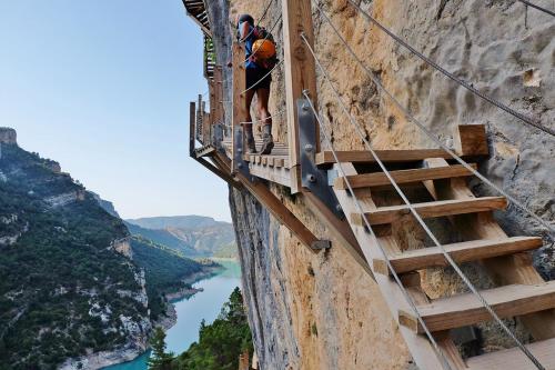 a man standing on a balcony looking at the side of a mountain at Casa Cosialls in Benabarre