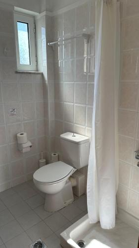 a white bathroom with a toilet and a shower at Cost Mari Almyrida New by ZAGO Boutiqe hotels in Almirida