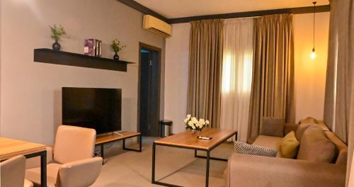 a living room with a couch and a tv at The Blowfish Hotel in Lagos