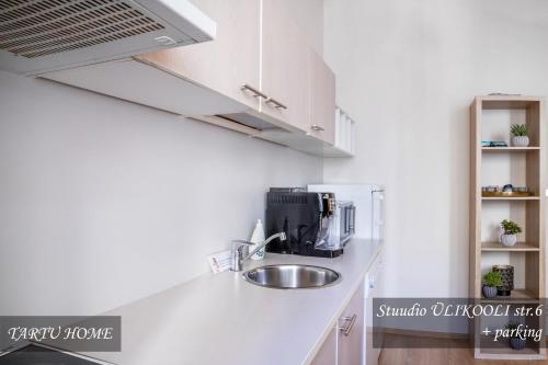 a kitchen with a sink and a coffee maker at University City Heart, Tartu Home in Tartu