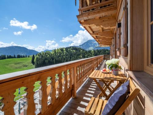a balcony with a table and a view of the mountains at Berggasthof Bichlersee in Oberaudorf