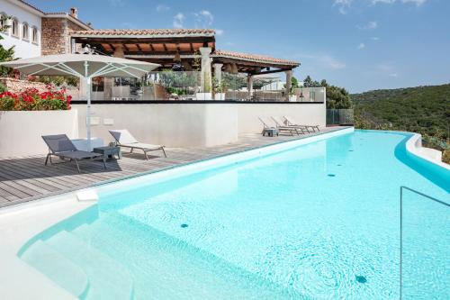 a swimming pool in a villa with a house at Hotel delle Rose a Luxury Boutique Hotel in Porto Cervo