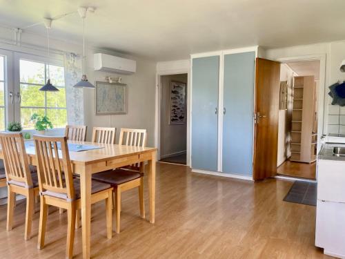 a kitchen and dining room with a wooden table and chairs at Holiday home Småland Gäddegölshult in Gäddegölshult