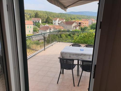 a view of a balcony with a table and chairs at Seaview in Vrboska