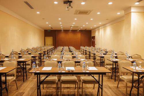 a large room with tables and chairs in it at Ramada By Wyndham Cappadocia in Ortahisar