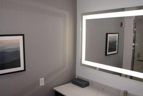 a bathroom with a mirror and a sink at La Quinta Inn & Suites by Wyndham Manchester - Arnold AFB in Manchester