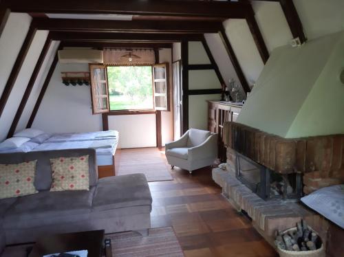 a living room with a couch and a fireplace at Holiday Home Bojko in Krapje