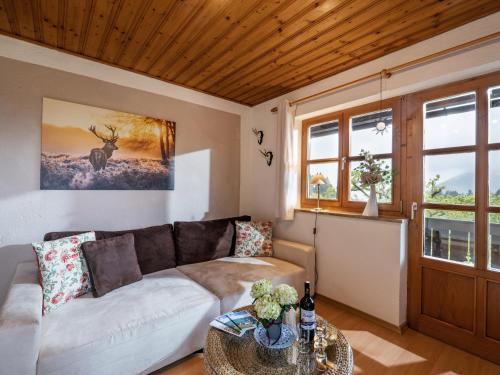 a living room with a couch and a table at Berggasthof Bichlersee in Oberaudorf