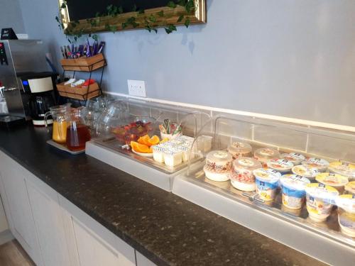 a kitchen counter with food in containers on it at Park Hotel & Apartments in Hull