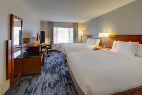a hotel room with two beds and a desk at Fairfield Inn & Suites by Marriott Fort Worth I-30 West Near NAS JRB in Fort Worth