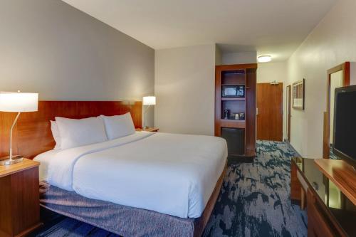 a hotel room with a large bed and a television at Fairfield Inn & Suites by Marriott Fort Worth I-30 West Near NAS JRB in Fort Worth
