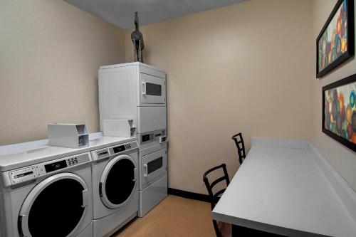 a laundry room with a washing machine and a table at Fairfield Inn & Suites by Marriott Fort Worth I-30 West Near NAS JRB in Fort Worth